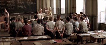 Movie still from “The Chorus” (2004), directed by Christophe Barratier – A class room full of students and an instructor; Wide shot, High angle