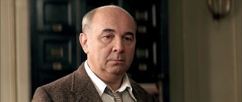 Movie still from “The Chorus” (2004), directed by Christophe Barratier – An older man wearing a jacket and tie; Close Up shot, Low angle