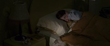 Movie still from “The Chronicles of Narnia: The Lion, the Witch and the Wardrobe” (2005), directed by Andrew Adamson – A girl is laying in a bed with a teddy bear; Medium shot, High angle