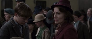 Movie still from “The Chronicles of Narnia: The Lion, the Witch and the Wardrobe” (2005), directed by Andrew Adamson – A group of people standing in a room with hats on; Close Up shot, Over the shoulder angle
