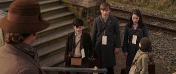 Movie still from “The Chronicles of Narnia: The Lion, the Witch and the Wardrobe” (2005), directed by Andrew Adamson – Two young boys are standing next to each other; Medium shot, Low angle