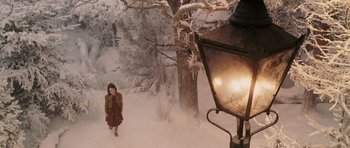 Movie still from “The Chronicles of Narnia: The Lion, the Witch and the Wardrobe” (2005), directed by Andrew Adamson – A woman standing next to a street light in the snow; Wide shot, High angle