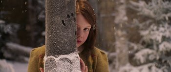 Movie still from “The Chronicles of Narnia: The Lion, the Witch and the Wardrobe” (2005), directed by Andrew Adamson – A young girl peeking around a wall in the snow; Close Up shot, Over the shoulder angle