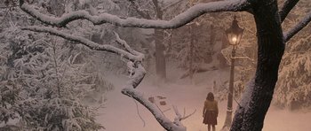 Movie still from “The Chronicles of Narnia: The Lion, the Witch and the Wardrobe” (2005), directed by Andrew Adamson – A person standing in the snow near some trees; Extreme Wide shot, High angle