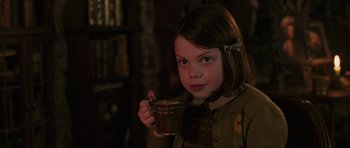 Movie still from “The Chronicles of Narnia: The Lion, the Witch and the Wardrobe” (2005), directed by Andrew Adamson – A young girl holding a cup of coffee; Close Up shot, Over the shoulder angle