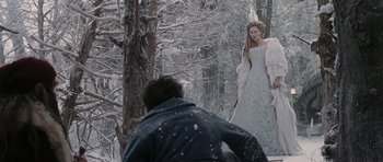 Movie still from “The Chronicles of Narnia: The Lion, the Witch and the Wardrobe” (2005), directed by Andrew Adamson – A man taking a picture of a woman in a white dress in the snow; Wide shot, Over the shoulder angle