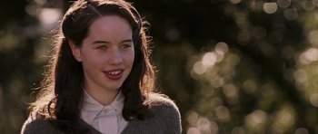 Movie still from “The Chronicles of Narnia: The Lion, the Witch and the Wardrobe” (2005), directed by Andrew Adamson – A young woman with long dark hair wearing a white shirt; Close Up shot, High angle