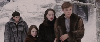 Movie still from “The Chronicles of Narnia: The Lion, the Witch and the Wardrobe” (2005), directed by Andrew Adamson – A group of people standing next to each other; Medium shot, Low angle