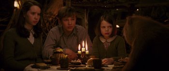 Movie still from “The Chronicles of Narnia: The Lion, the Witch and the Wardrobe” (2005), directed by Andrew Adamson – A boy and a little girl sitting at a table with candles; Medium shot, High angle