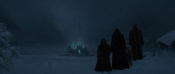 Movie still from “The Chronicles of Narnia: The Lion, the Witch and the Wardrobe” (2005), directed by Andrew Adamson – Two people standing in the snow looking at a castle; Extreme Wide shot, Low angle