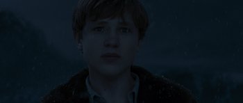 Movie still from “The Chronicles of Narnia: The Lion, the Witch and the Wardrobe” (2005), directed by Andrew Adamson – A young man in a jacket looking into the distance; Close Up shot, Low angle