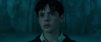 Movie still from “The Chronicles of Narnia: The Lion, the Witch and the Wardrobe” (2005), directed by Andrew Adamson – A young man with a black jacket and white shirt; Close Up shot, Low angle