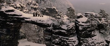 Movie still from “The Chronicles of Narnia: The Lion, the Witch and the Wardrobe” (2005), directed by Andrew Adamson – A group of people standing on top of a snow covered cliff; Extreme Wide shot, High angle