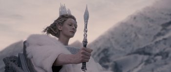 Movie still from “The Chronicles of Narnia: The Lion, the Witch and the Wardrobe” (2005), directed by Andrew Adamson – A woman in a white fur coat holding a spear; Close Up shot, Low angle