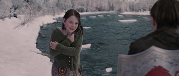 Movie still from “The Chronicles of Narnia: The Lion, the Witch and the Wardrobe” (2005), directed by Andrew Adamson – A young girl standing next to a body of water; Medium shot, Over the shoulder angle