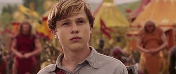 Movie still from “The Chronicles of Narnia: The Lion, the Witch and the Wardrobe” (2005), directed by Andrew Adamson – A young man in a gray shirt and a red tie; Close Up shot, Low angle