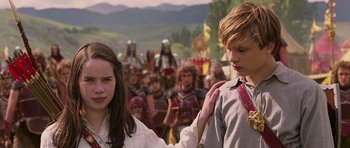 Movie still from “The Chronicles of Narnia: The Lion, the Witch and the Wardrobe” (2005), directed by Andrew Adamson – A couple of people standing next to each other in a field; Medium shot, Over the shoulder angle