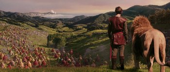 Movie still from “The Chronicles of Narnia: The Lion, the Witch and the Wardrobe” (2005), directed by Andrew Adamson – A man standing in a field looking out at the mountains; Extreme Wide shot, Over the shoulder angle