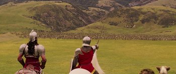 Movie still from “The Chronicles of Narnia: The Lion, the Witch and the Wardrobe” (2005), directed by Andrew Adamson – A man in a red and white outfit riding a horse; Extreme Wide shot, High angle