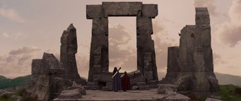 Movie still from “The Chronicles of Narnia: The Lion, the Witch and the Wardrobe” (2005), directed by Andrew Adamson – Two people standing in front of an ancient stone structure; Extreme Wide shot, Low angle