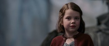 Movie still from “The Chronicles of Narnia: The Lion, the Witch and the Wardrobe” (2005), directed by Andrew Adamson – A little girl wearing a red sweater and a necklace; Close Up shot, Over the shoulder angle
