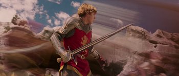 Movie still from “The Chronicles of Narnia: The Lion, the Witch and the Wardrobe” (2005), directed by Andrew Adamson – A man dressed as a knight holding a sword; Medium shot, Low angle