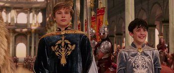 Movie still from “The Chronicles of Narnia: The Lion, the Witch and the Wardrobe” (2005), directed by Andrew Adamson – A young man in medieval garb standing in front of a group of people; Medium shot, Low angle