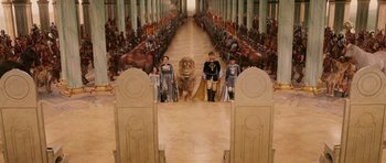 Movie still from “The Chronicles of Narnia: The Lion, the Witch and the Wardrobe” (2005), directed by Andrew Adamson – A group of people standing in a room with a lion; Extreme Wide shot, High angle