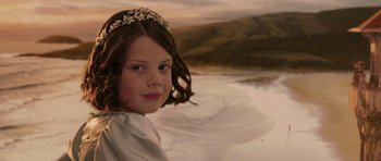 Movie still from “The Chronicles of Narnia: The Lion, the Witch and the Wardrobe” (2005), directed by Andrew Adamson – A young girl wearing a tiara in front of the ocean; Close Up shot, High angle