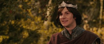 Movie still from “The Chronicles of Narnia: The Lion, the Witch and the Wardrobe” (2005), directed by Andrew Adamson – A young man wearing a crown in a forest; Close Up shot, Low angle