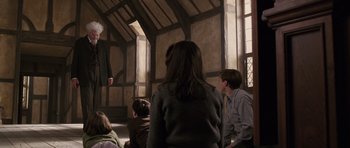 Movie still from “The Chronicles of Narnia: The Lion, the Witch and the Wardrobe” (2005), directed by Andrew Adamson – A group of people sitting in front of an audience; Wide shot, Low angle