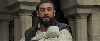 Movie still from “The Chronicles of Narnia: Prince Caspian” (2008), directed by Andrew Adamson – A man with a beard holding a baby in his arms; Close Up shot, Over the shoulder angle