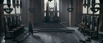 Movie still from “The Chronicles of Narnia: Prince Caspian” (2008), directed by Andrew Adamson – A man walking down a staircase in a building; Extreme Wide shot, High angle
