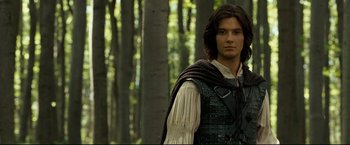 Movie still from “The Chronicles of Narnia: Prince Caspian” (2008), directed by Andrew Adamson – A young man in medieval garb standing in the woods; Medium shot, Low angle