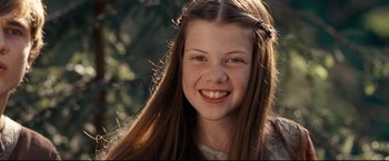 Movie still from “The Chronicles of Narnia: Prince Caspian” (2008), directed by Andrew Adamson – A young girl smiling for the camera with her hair in the air; Close Up shot, High angle