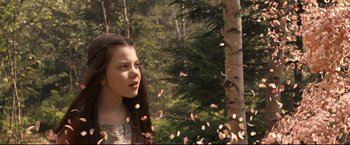 Movie still from “The Chronicles of Narnia: Prince Caspian” (2008), directed by Andrew Adamson – A young girl standing in front of a tree with a bunch of leaves falling from it; Close Up shot, Low angle