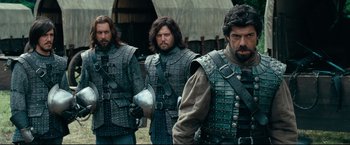 Movie still from “The Chronicles of Narnia: Prince Caspian” (2008), directed by Andrew Adamson – A group of men in medieval garb standing next to each other; Medium shot, Over the shoulder angle