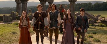 Movie still from “The Chronicles of Narnia: Prince Caspian” (2008), directed by Andrew Adamson – A group of people standing next to each other on a walkway; Wide shot, Low angle