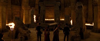 Movie still from “The Chronicles of Narnia: Prince Caspian” (2008), directed by Andrew Adamson – A group of people standing in front of a fire pit; Wide shot, High angle