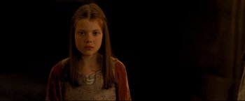 Movie still from “The Chronicles of Narnia: Prince Caspian” (2008), directed by Andrew Adamson – A young girl with long brown hair in a white dress; Close Up shot, High angle