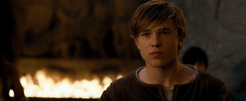 Movie still from “The Chronicles of Narnia: Prince Caspian” (2008), directed by Andrew Adamson – A young man standing in front of a fireplace; Close Up shot, High angle