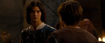 Movie still from “The Chronicles of Narnia: Prince Caspian” (2008), directed by Andrew Adamson – A young man in medieval garb looking into a mirror; Close Up shot, Over the shoulder angle