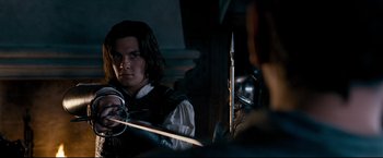 Movie still from “The Chronicles of Narnia: Prince Caspian” (2008), directed by Andrew Adamson – A man in medieval garb is holding a sword; Medium shot, Over the shoulder angle