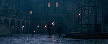 Movie still from “The Chronicles of Narnia: Prince Caspian” (2008), directed by Andrew Adamson – A group of people walking down a street with torches; Extreme Wide shot, High angle