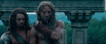 Movie still from “The Chronicles of Narnia: Prince Caspian” (2008), directed by Andrew Adamson – A man with long dreadlocks is holding his arm up; Close Up shot, Low angle