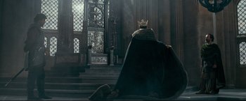 Movie still from “The Chronicles of Narnia: Prince Caspian” (2008), directed by Andrew Adamson – A man wearing a crown sitting in front of a staircase; Wide shot, Low angle