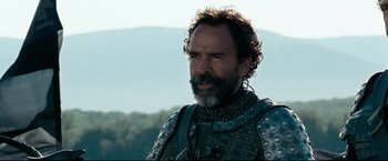Movie still from “The Chronicles of Narnia: Prince Caspian” (2008), directed by Andrew Adamson – A man with a beard wearing a chain mail outfit; Close Up shot, Low angle