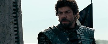 Movie still from “The Chronicles of Narnia: Prince Caspian” (2008), directed by Andrew Adamson – A person wearing armor and a beard; Close Up shot, Over the shoulder angle