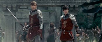 Movie still from “The Chronicles of Narnia: Prince Caspian” (2008), directed by Andrew Adamson – Two young men dressed in medieval costumes are walking; Medium shot, Low angle