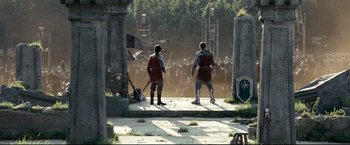 Movie still from “The Chronicles of Narnia: Prince Caspian” (2008), directed by Andrew Adamson – Two men in medieval garb standing in front of a group of people; Wide shot, Low angle